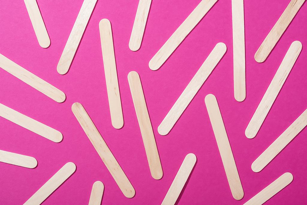 top view of depilation wooden sticks on pink background - Photo, Image