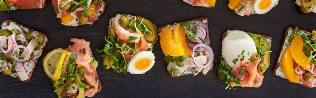 πανοραμική λήψη ψωμιού σίκαλης με νόστιμα σάντουιτς smorrebrod σε γκρι επιφάνεια  - Φωτογραφία, εικόνα