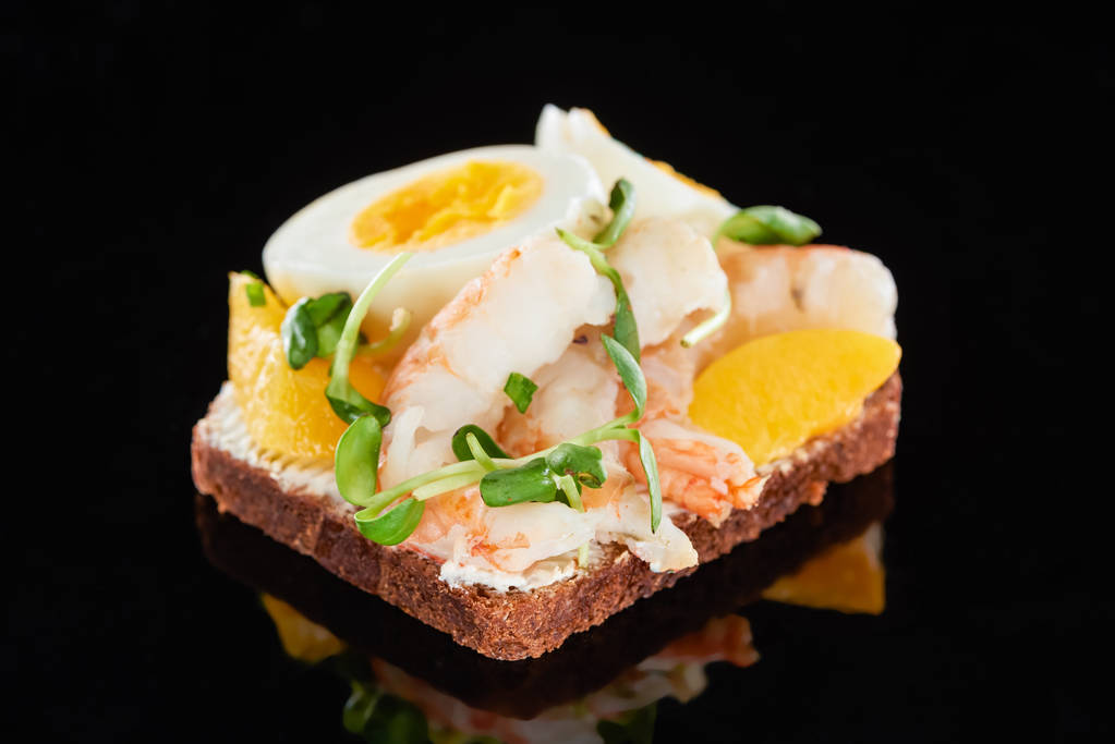 close up of tasty shrimps on smorrebrod sandwich on black  - Photo, Image