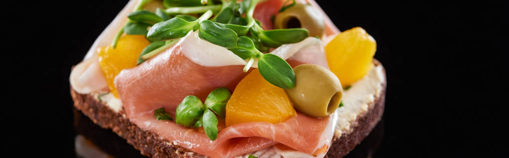 panoramic shot of ham and olives on cooked danish smorrebrod sandwich on black  - Photo, Image