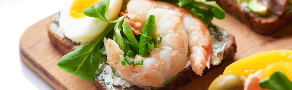 panoramic shot of smorrebrod sandwich with tasty shrimps on white  - Photo, Image