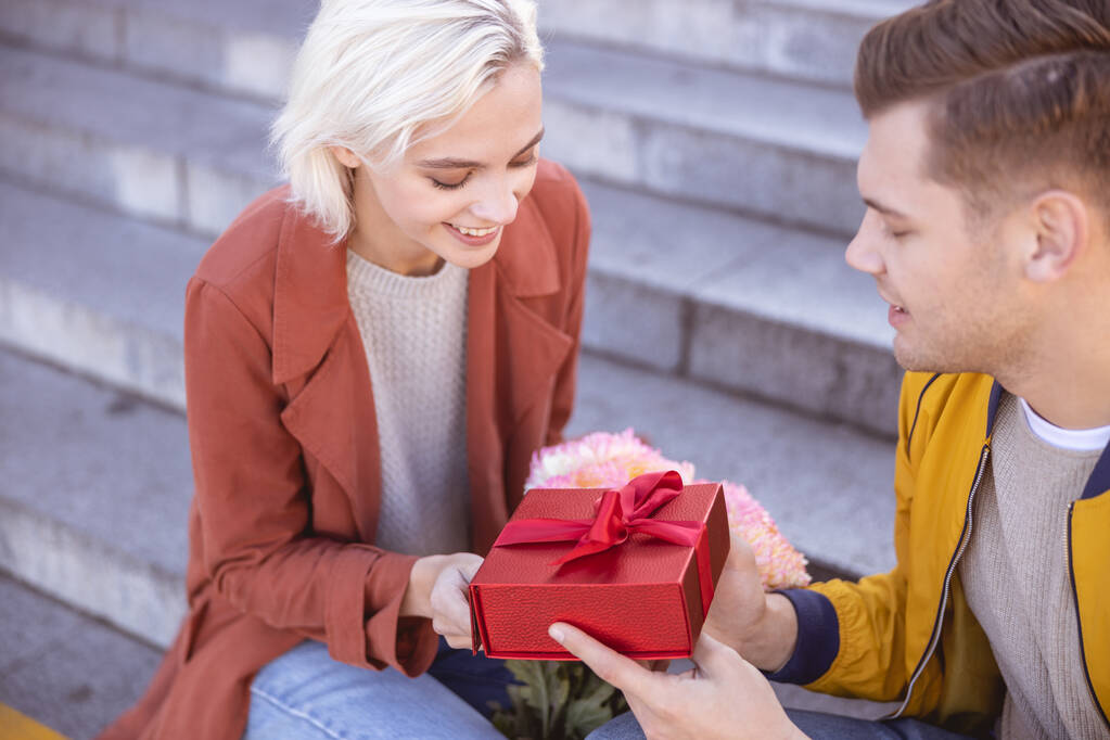 Woman being pleased receiving a birthday gift - Photo, Image