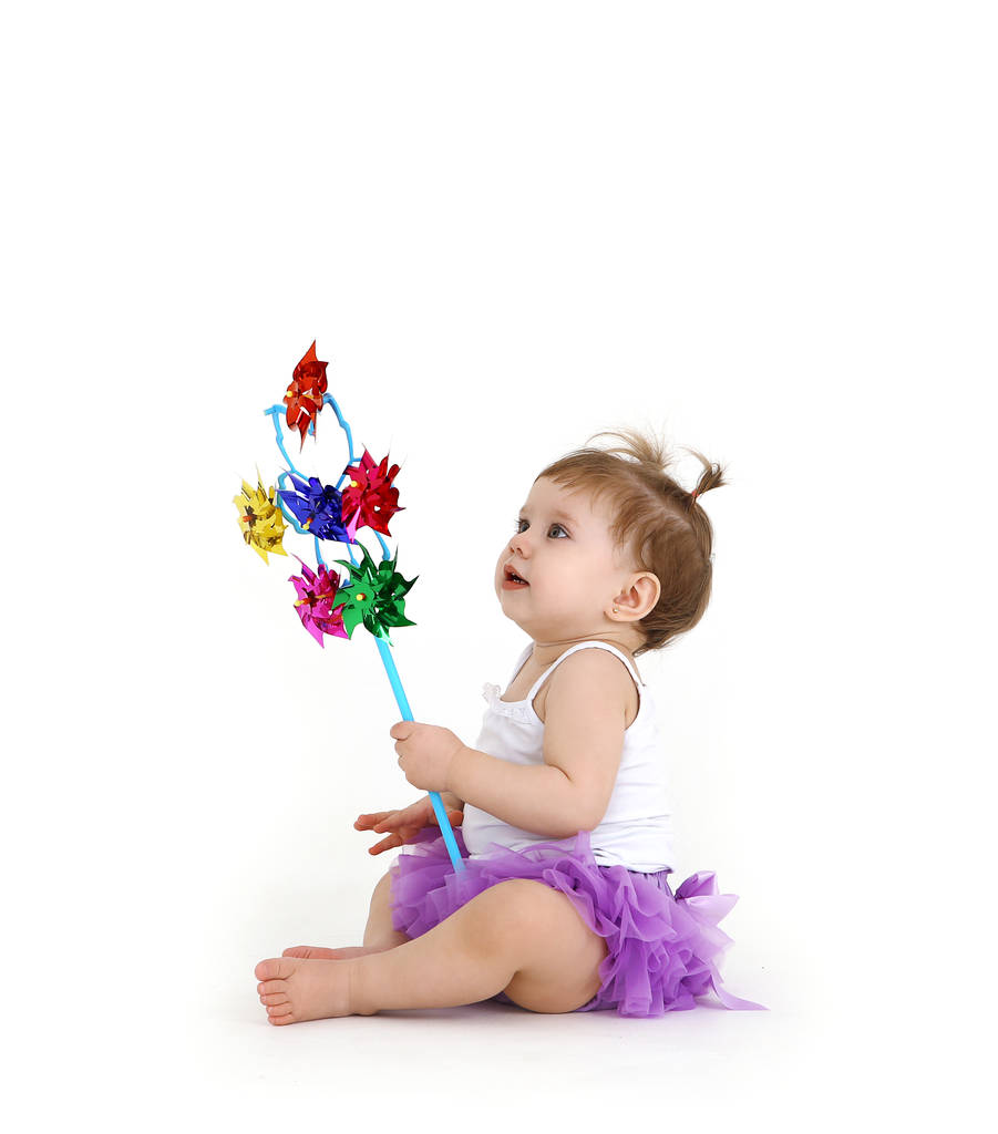 little girl with pinwheel in hands on white background - Photo, Image
