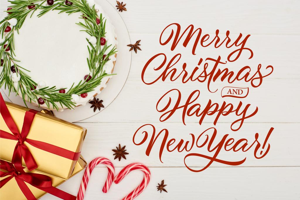 Noel pastası, anasonlu yıldız tohumları, bastonlar ve hediye kutuları beyaz ahşap masa üzerinde Mutlu Noeller ve mutlu yeni yıl illüstrasyonları - Fotoğraf, Görsel