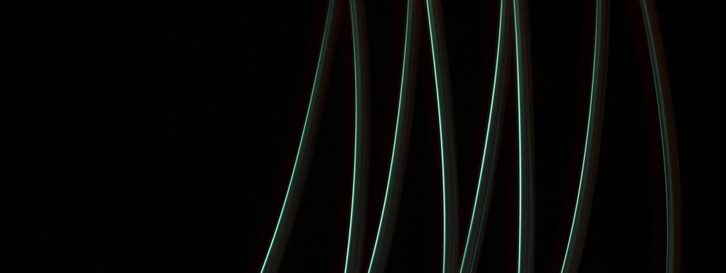 Кривые линии зеленого света на чёрном фоне - Фото, изображение