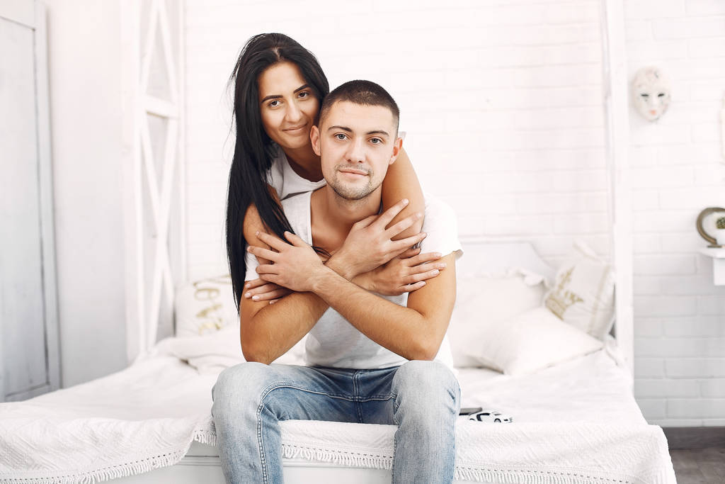 Beautiful couple spend time in a bedroom - Photo, Image