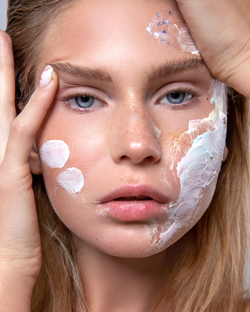 beauty portrait of a girl using skin care cosmetics - Photo, Image