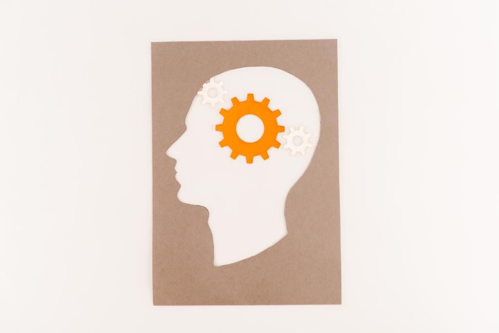 top view of human head silhouette with orange gear isolated on white - Photo, Image