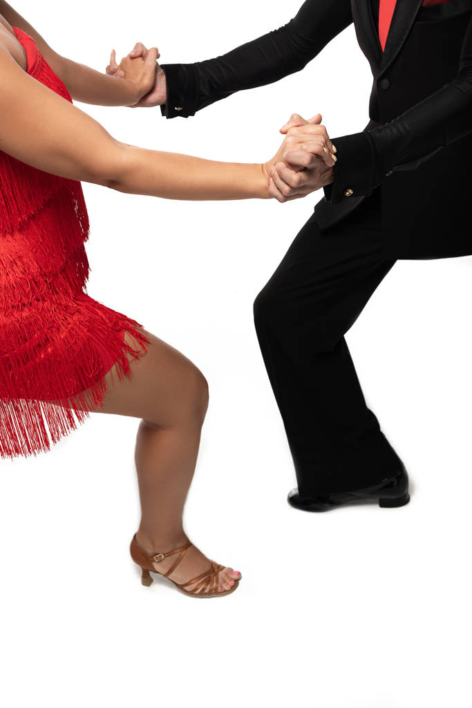 vista cortada de dançarinos elegantes realizando tango no fundo branco
 - Foto, Imagem