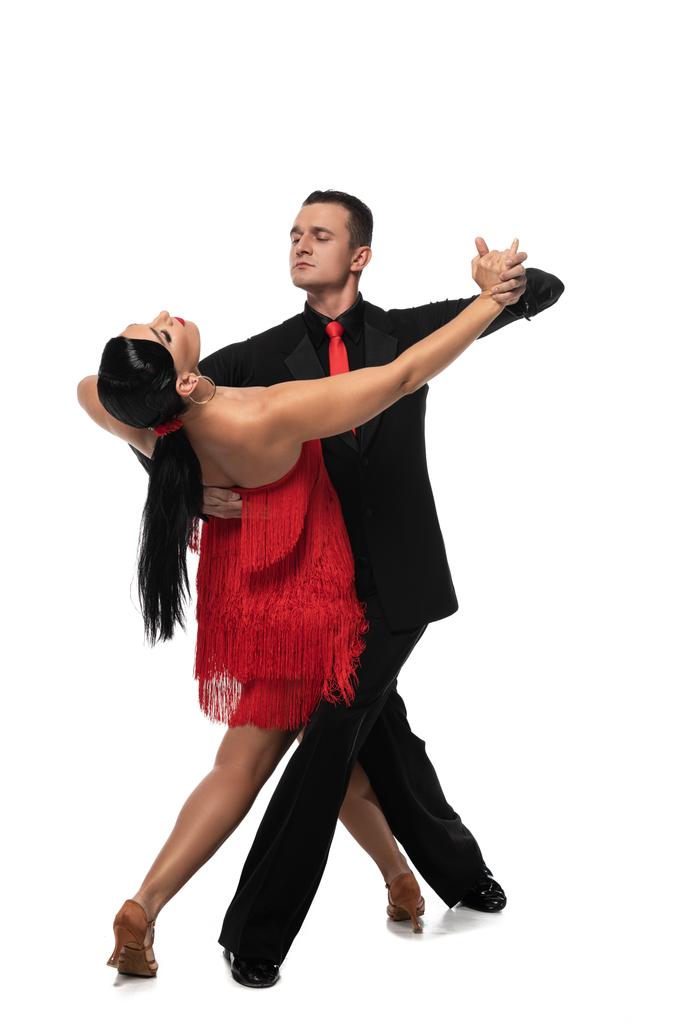 handsome, elegant dancer leading attractive partner while performing tango on white background - Photo, Image