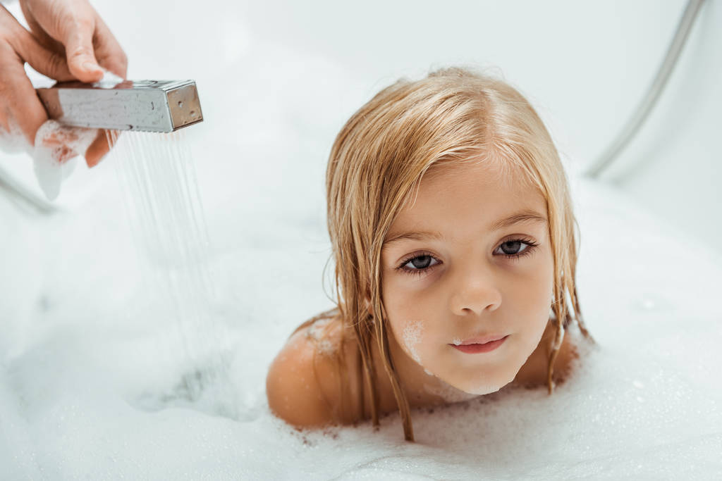 cute and nude kid taking bath near mother in bathroom  - Photo, Image