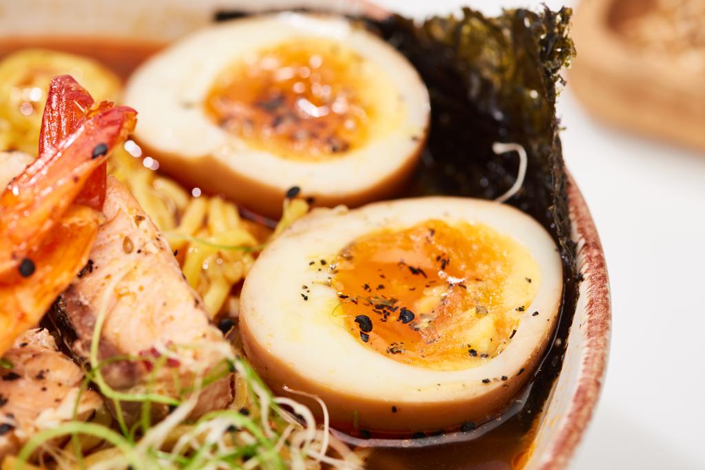 close up view of spicy seafood ramen with egg in bowl - Photo, Image