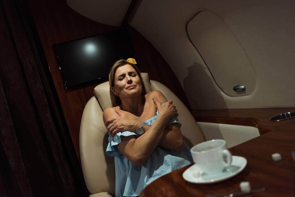 selective focus of terrified woman sitting in private plane - Photo, Image