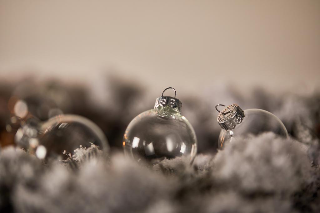palline di Natale trasparenti su rami di abete rosso nella neve
 - Foto, immagini