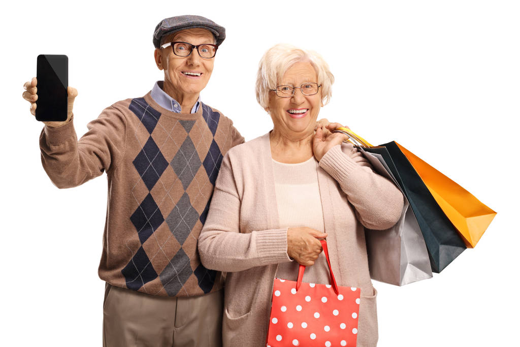 Улыбающиеся пожилые люди с мобильным телефоном и сумками для покупок
  - Фото, изображение