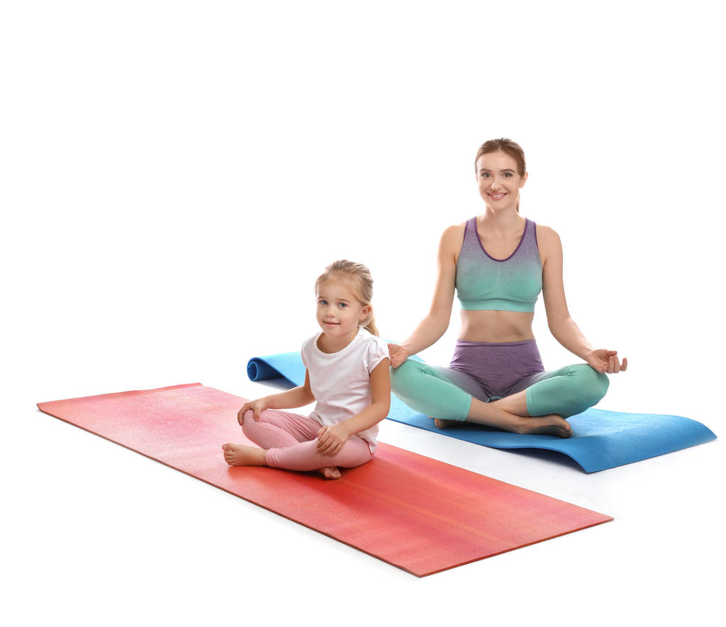 Jeune femme et sa fille faisant de l'exercice isolé sur blanc. Fitness à domicile
 - Photo, image