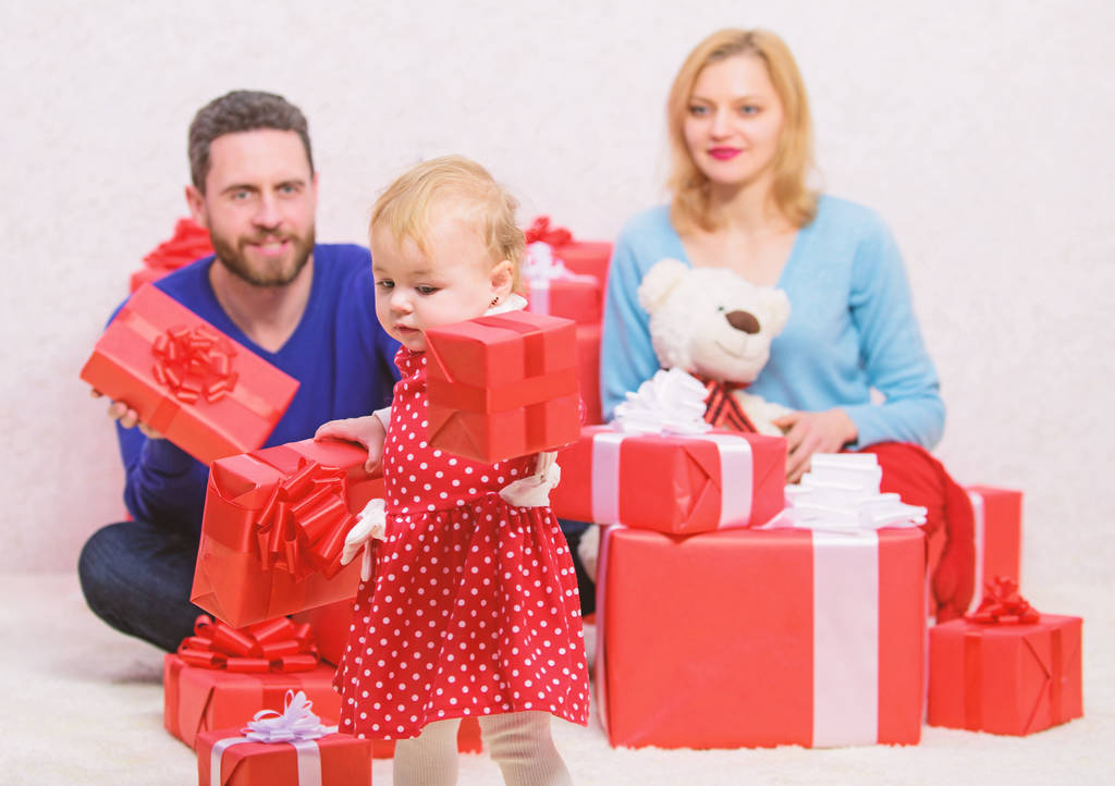 Loving everything about her. Valentines day. Red boxes. Love and trust in family. Bearded man and woman with little girl. father, mother and doughter child. Boxing day. Happy family with present box - Photo, Image