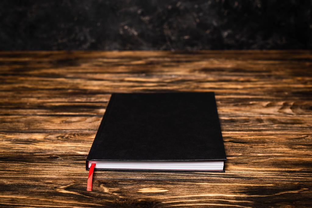 fekete könyv fa asztalon - Fotó, kép