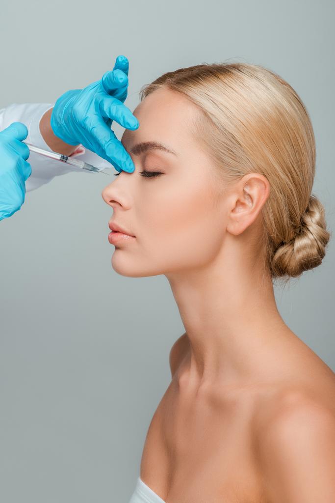 cosmetologista vista cortada fazendo injeção de beleza para mulher bonita isolado em cinza
 - Foto, Imagem