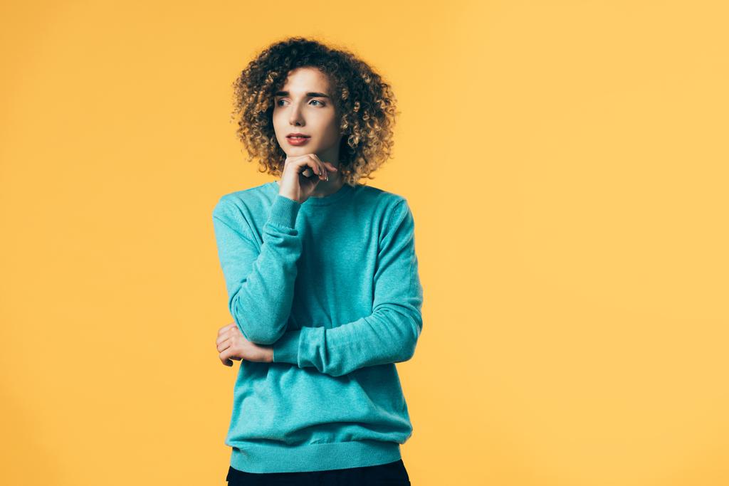 dreamy curly teenager looking away isolated on yellow - Photo, Image
