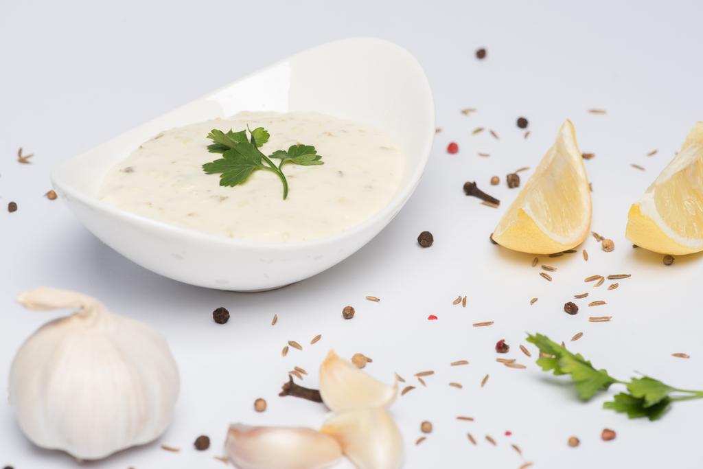 Delicious tzatziki sauce with garlic, lemon and spices on white background - Photo, Image