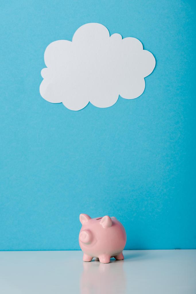 pink piggy bank near white cloud on blue with copy space  - Photo, Image