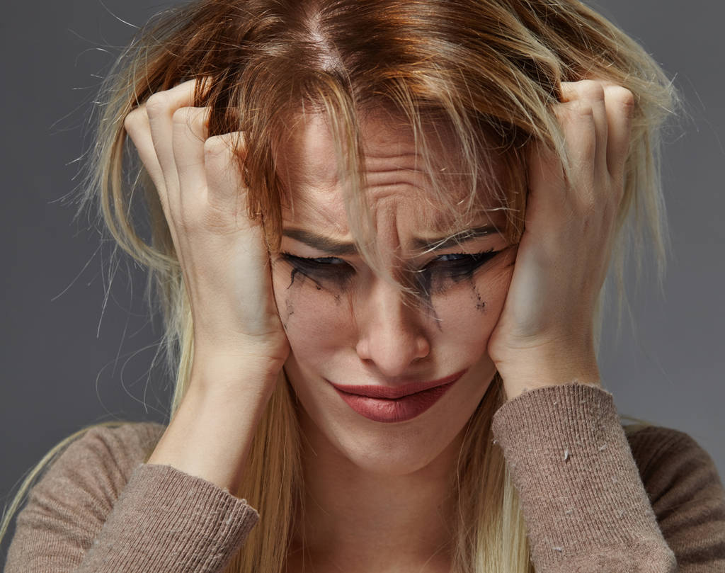 woman suffering from stress or headache while being offended by pain, - Photo, Image