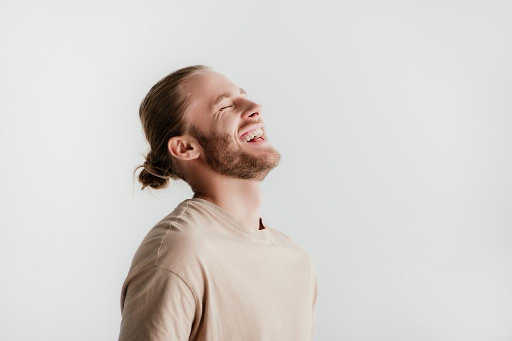 heureux jeune bel homme en tenue beige riant isolé sur blanc
 - Photo, image