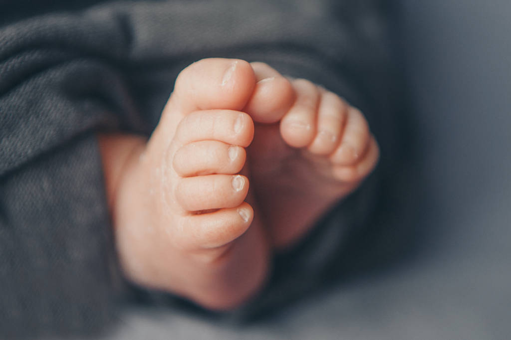 Newborn Baby's feet. legs massage concept of childhood, health care, IVF, hygiene - 写真・画像