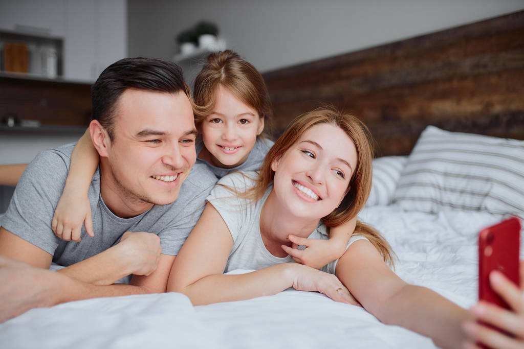 happy smiling family take selfie on bed - Photo, Image