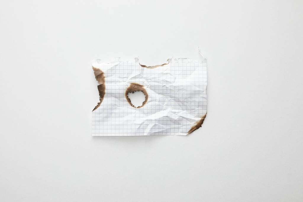 top view of empty crumpled and burnt vintage paper on white background - Photo, Image