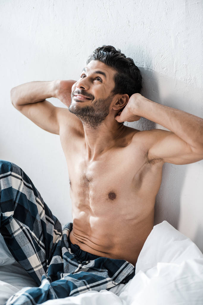 handsome and sexy bi-racial man with hands on head smiling in morning  - Photo, Image
