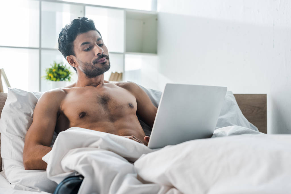 handsome and sexy bi-racial man using laptop in morning  - Photo, Image