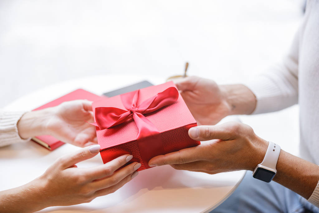 Focused photo on two people that holding gift box - Photo, Image