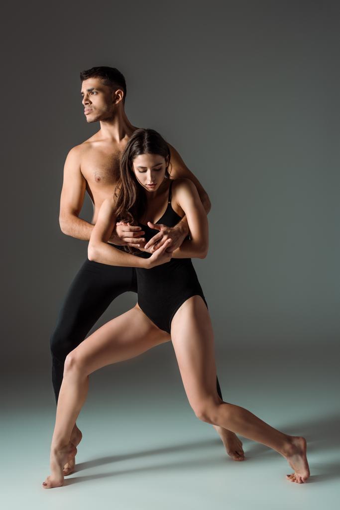 bailarines atractivos y guapos bailando contemporáneo sobre fondo oscuro
  - Foto, imagen