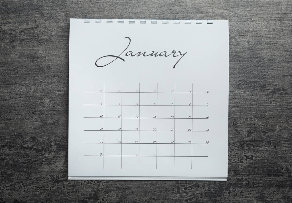 Januari kalender op grijze stenen achtergrond, bovenaanzicht - Foto, afbeelding
