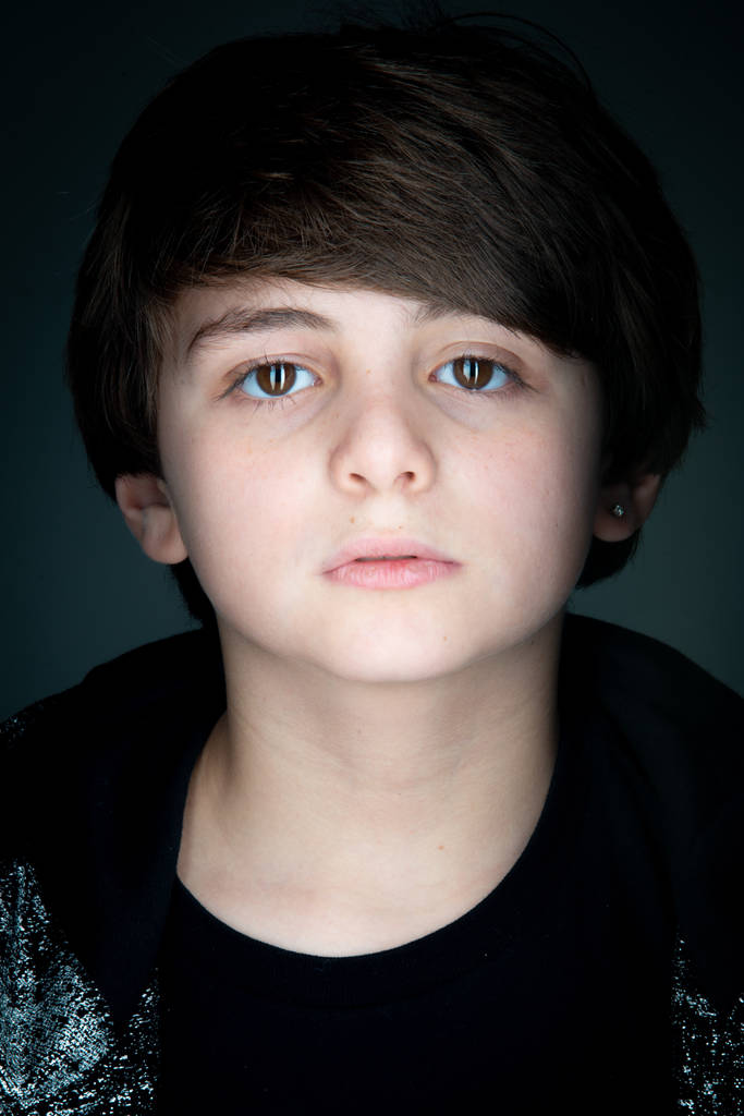 boy studio close up portrait in black zip hoodie on gray background - Photo, Image