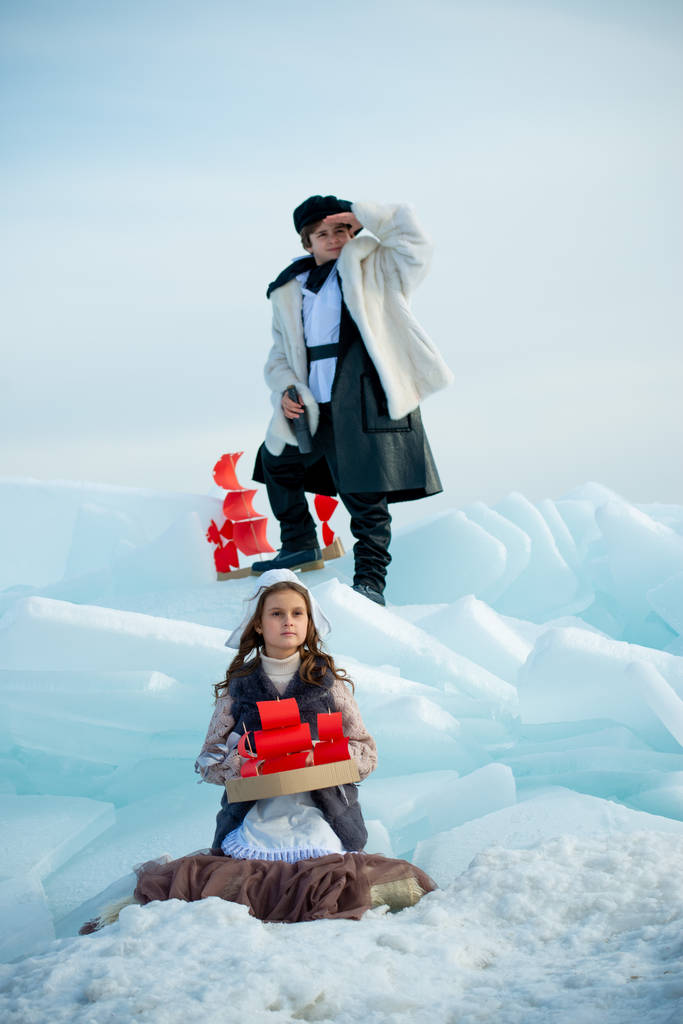 дети играют на айсберге с деревянными корабельными игрушками на зимнем фоне
 - Фото, изображение