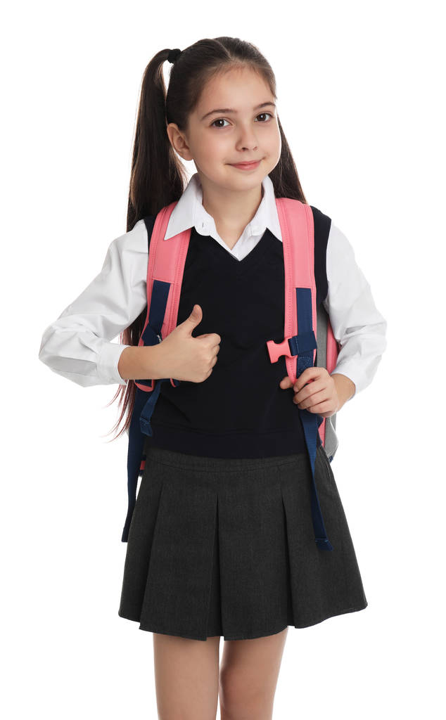 Маленькая девочка в школьной форме с рюкзаком на белом фоне
 - Фото, изображение