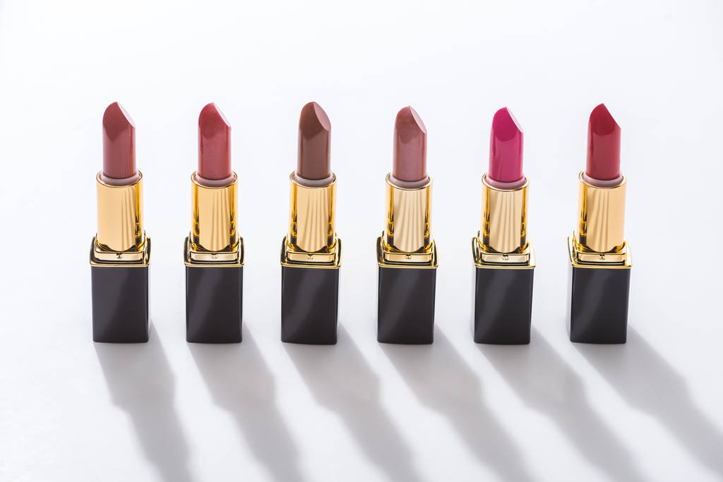 assorted lipsticks in luxury tubes in line on white background - Photo, Image