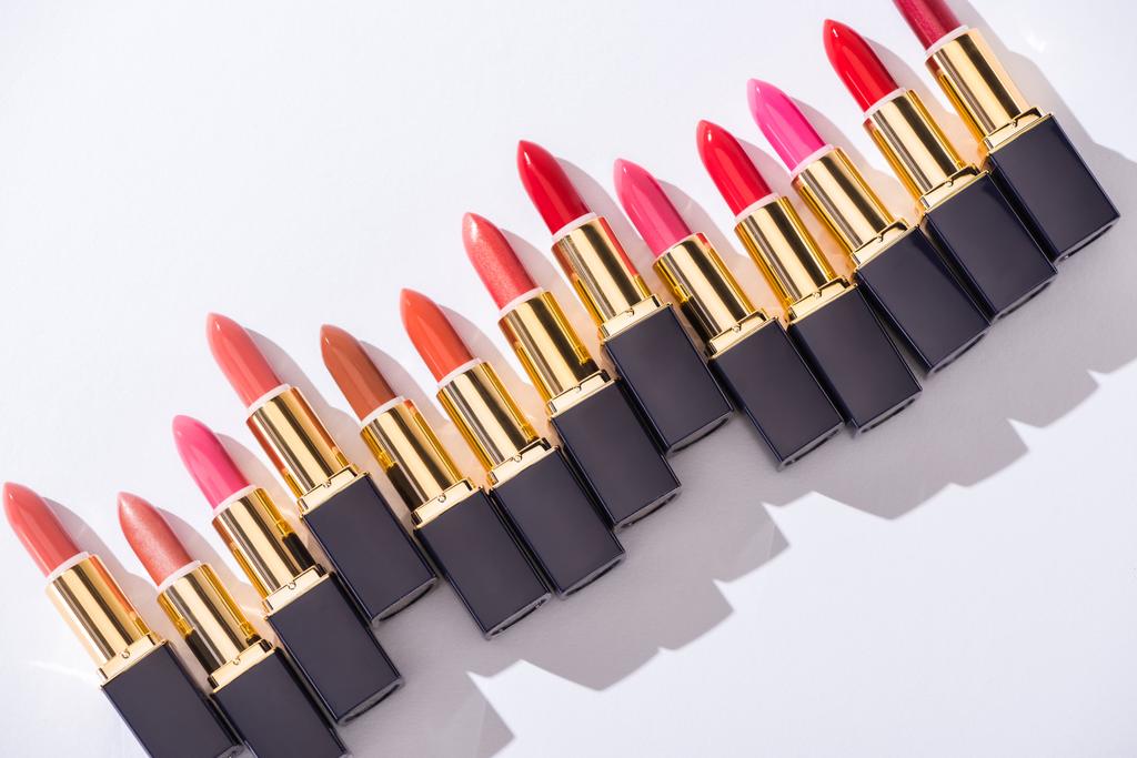 top view of assorted lipsticks in luxury tubes on white background - Photo, Image