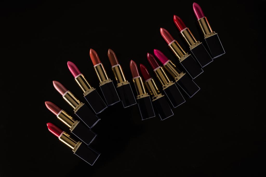 top view of assorted lipsticks in luxury tubes isolated on black - Photo, Image