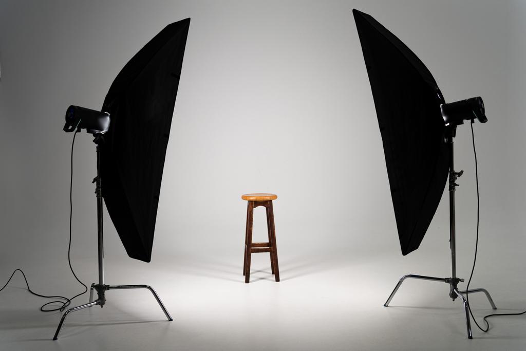 Wooden stool with studio light on grey background - Photo, Image