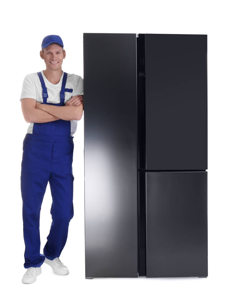 Professional worker near refrigerator on white background - Photo, Image