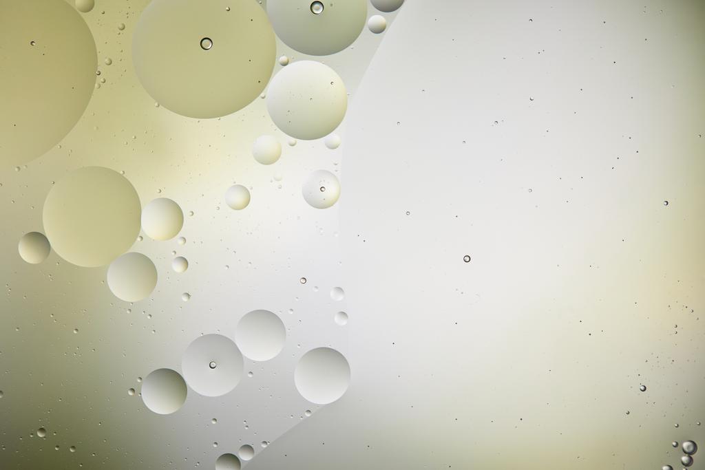 creatieve achtergrond van gemengde water en olie bellen in licht groene en grijze kleur - Foto, afbeelding