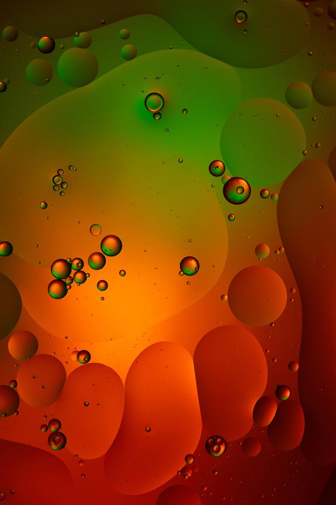green and red color abstract background from mixed water and oil bubbles  - Photo, Image