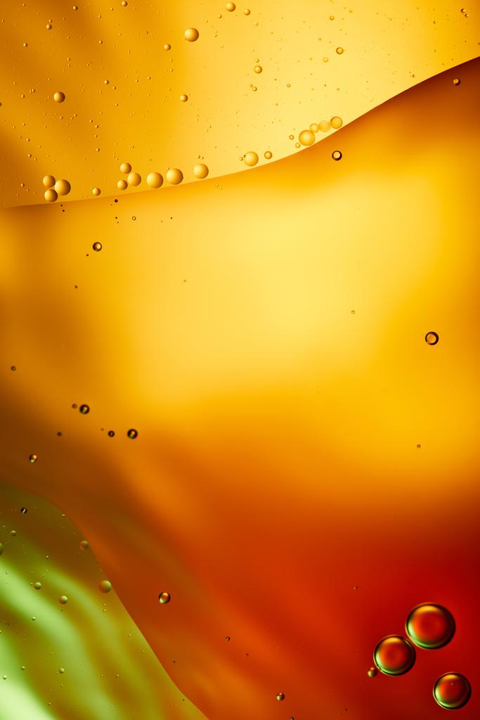 Krásné abstraktní pozadí ze smíšené vody a oleje v oranžové, červené a zelené barvě - Fotografie, Obrázek
