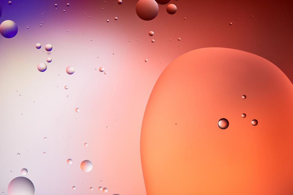 Beautiful abstract background from mixed water and oil bubbles in red and purple color - Photo, Image