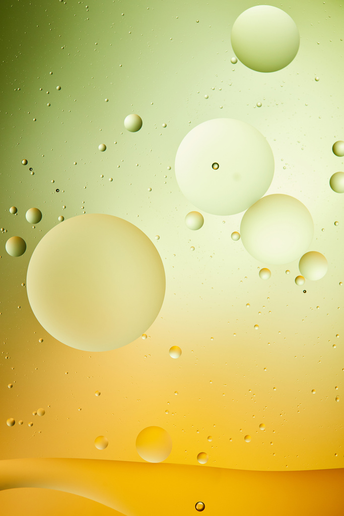 kreatywne tło z mieszanej wody i oleju w kolorze zielonym i pomarańczowym - Zdjęcie, obraz