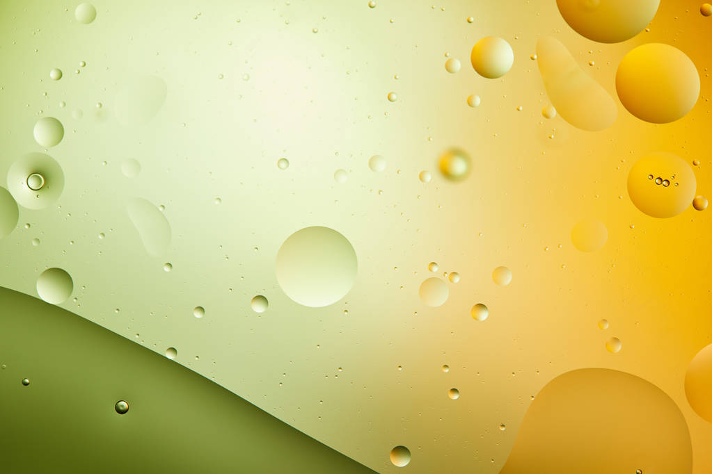 緑とオレンジの混合水と油からの抽象的な創造的な背景 - 写真・画像